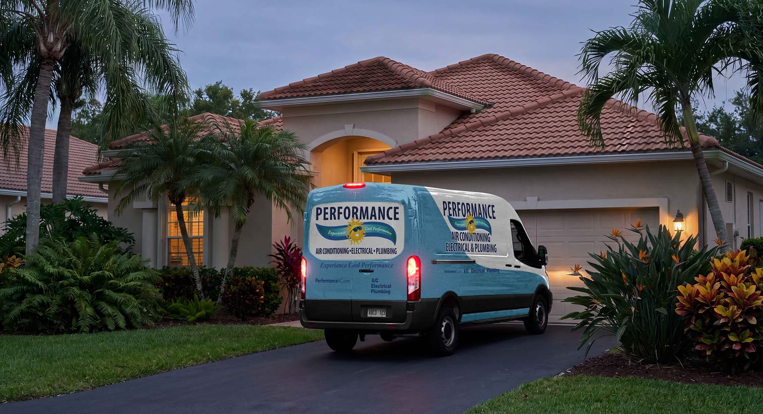 A Performance service van parked in a residential driveway at night, arriving to provide 24/7 emergency plumbing services.