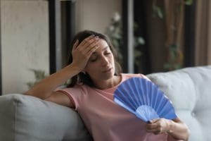 woman with a fan because ofair conditioning dehumidifier not working