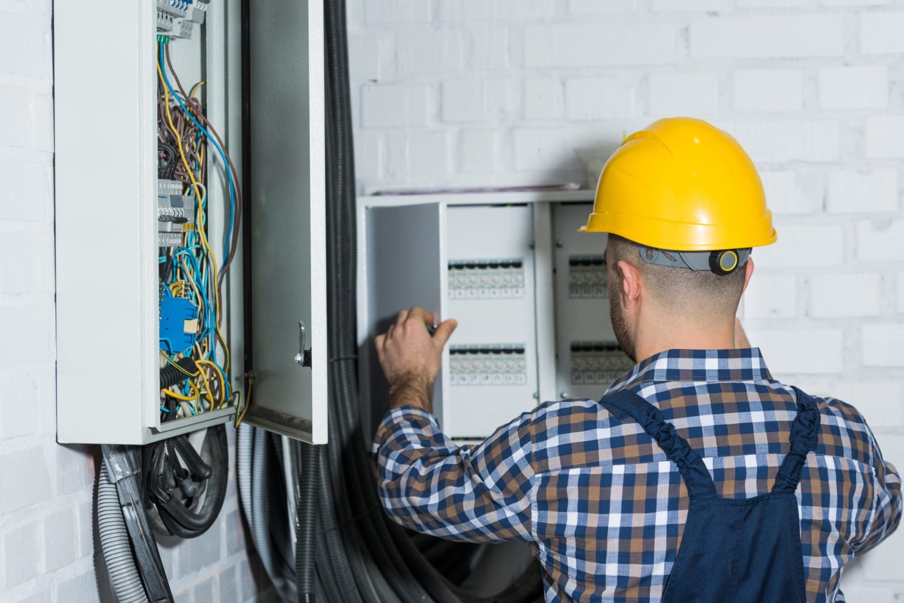 Male residential electrician performing an electrical repair